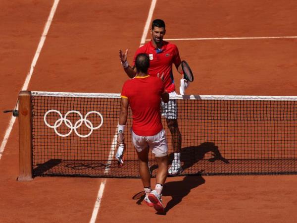 PARIS, FRANCE - JULY 29: Winner Novak Djokovic of Team Serbia  is co<em></em>ngratulated by Rafael Nadal of Team Spain after the Men's Singles second round match on day three of the Olympic Games Paris 2024 at Roland Garros on July 29, 2024 in Paris, France. (Photo by Matthew Stockman/Getty Images)