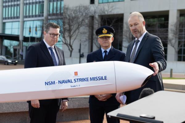 Minister for Defence Industry and Capability Pat Conroy, Air Marshal Leon Phillips and general manager of Ko<em></em>ngsberg Defence Australia John Fry with a model of the naval strike missile in Canberra on Thursday.