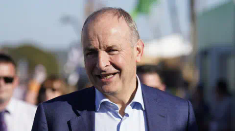 PA Tánaiste Micheál Martin at the Natio<em></em>nal Ploughing Champio<em></em>nships wearing a dark blue suit and like blue suit