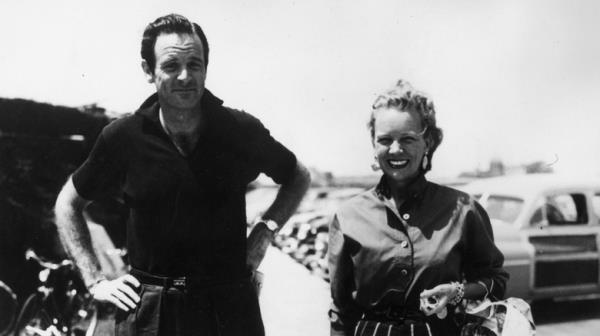 William and Ann Woodward smiling in front of cars