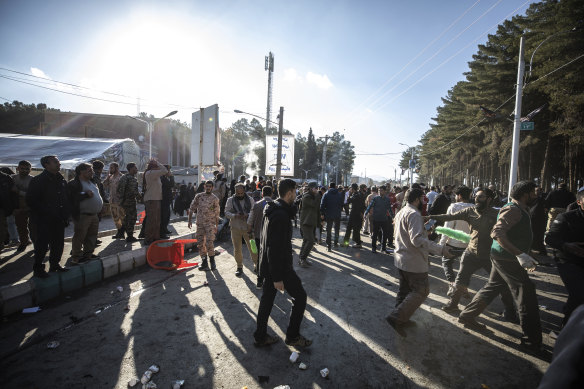 People are seen after an explosion in Kerman, Iran, on Wednesday.